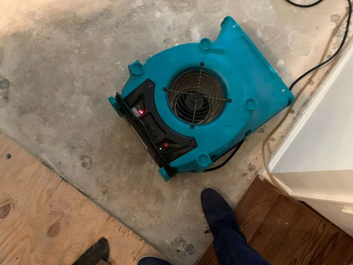 Air mover drying subfloor during Leak Detection & Repair in North Hempstead